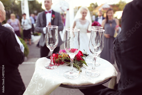 Waiter with four glasses of champagne