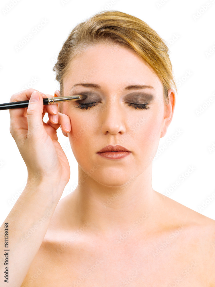 Applying makeup on beautiful model