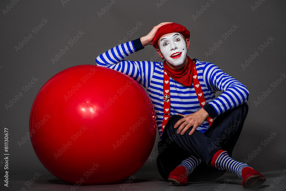 Mime with big red ball in hands Mime with big red ball in hands