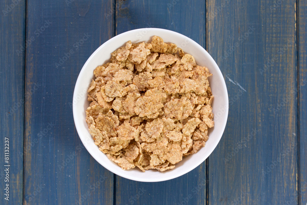 cereals in bowl on blue background cereals in bowl on blue background