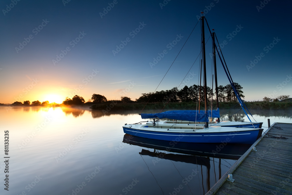 yachts on lake pier at sunrise