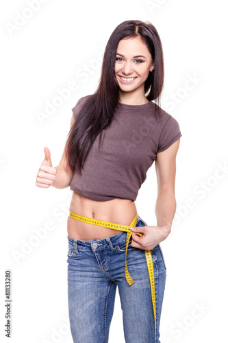 Young Woman measuring her waist - Stock Image