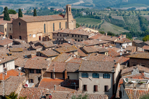 Sant Agostino church and houses rooftops at San Gimignano photo