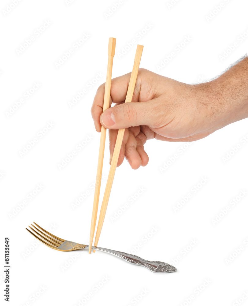 Hand with chopsticks and fork Hand with chopsticks and fork
