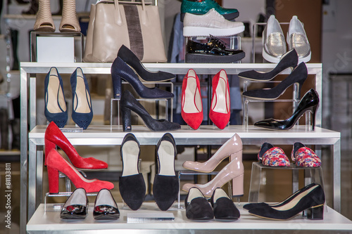 Large selection of women's shoes on the shelf in the store photo