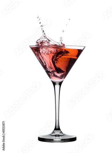 red martini cocktail splashing in glass isolated on white