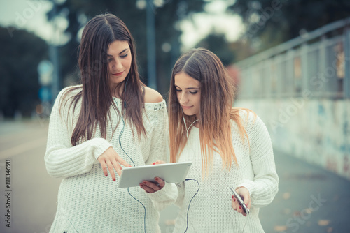 young couple beautiful women girls autumn using tablet