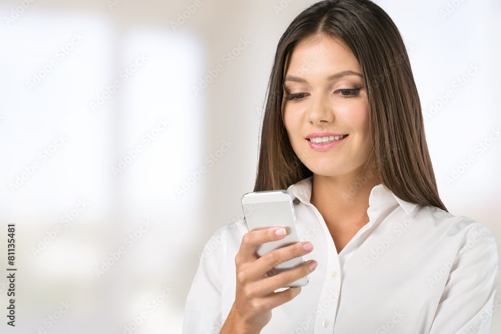 Adult. Portrait of a beautiful woman typing on the smart phone