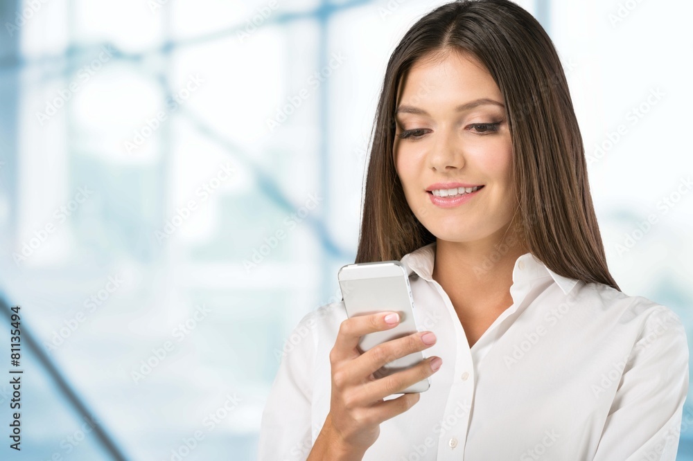 Adult. Portrait of a beautiful woman typing on the smart phone