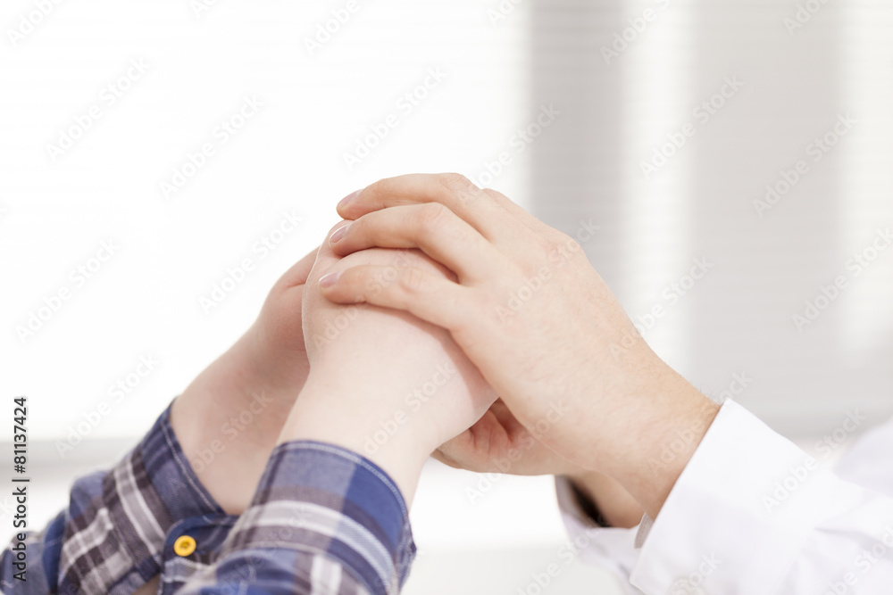 Doctor hands comforting his female patient