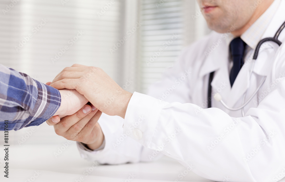 Doctor comforting his female patient