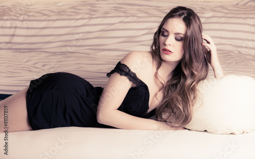 Tableau sur toile Seductive woman in lingerie on bed.