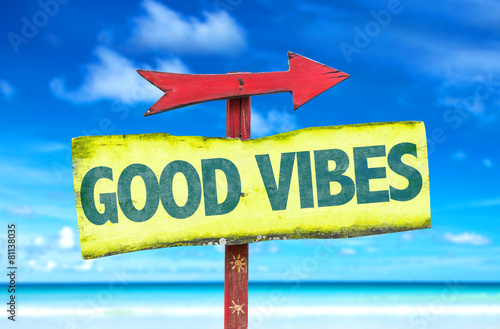 Good Vibes sign with beach background