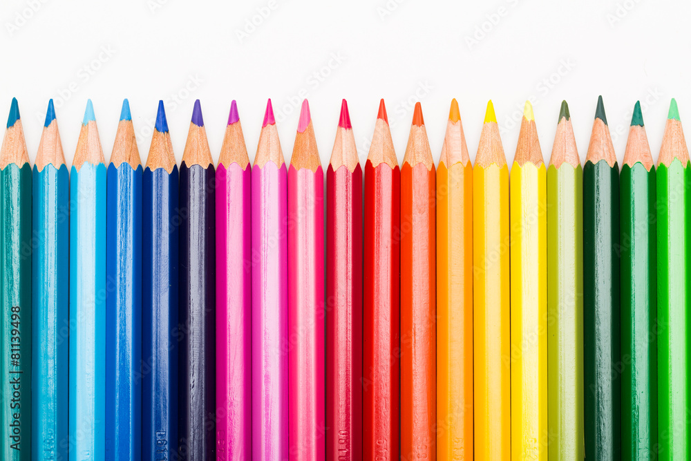 Colored pencils lined up in row Colored pencils lined up in row