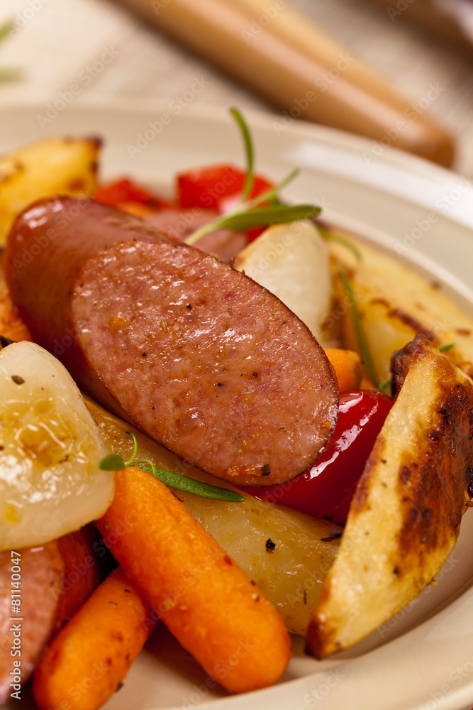 Roasted Sausages and Potato Dinner. Selective focus. Roasted Sausages and Potato Dinner. Selective focus.
