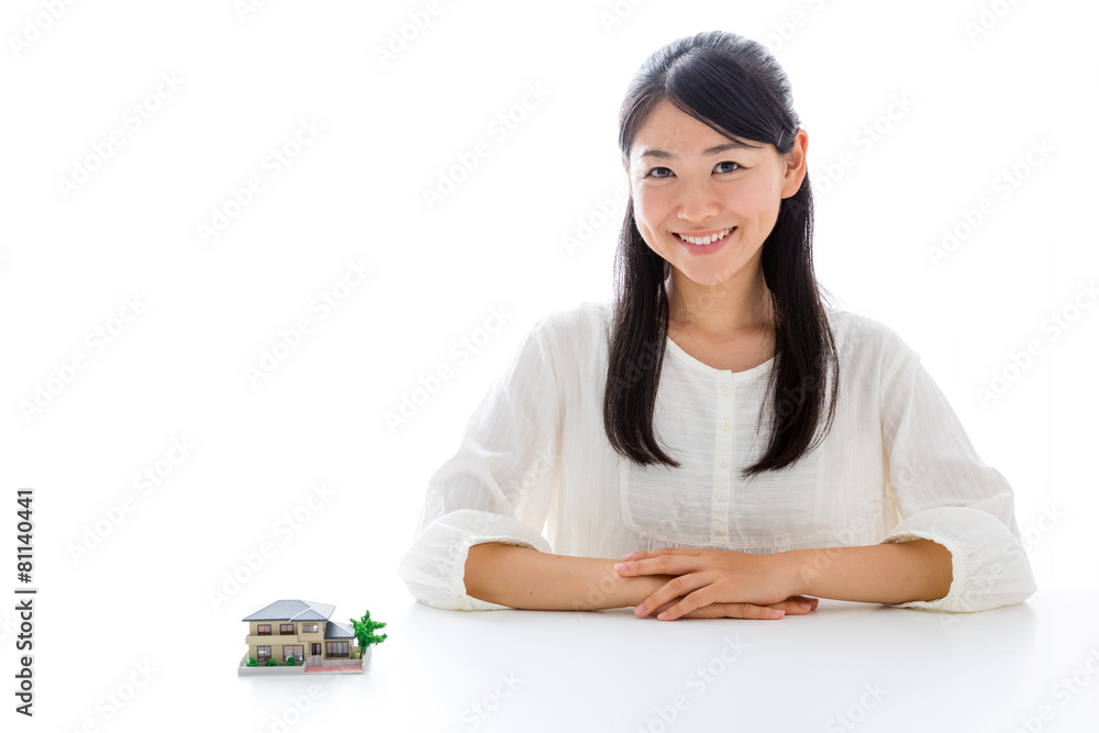 young asian woman with miniature house young asian woman with miniature house
