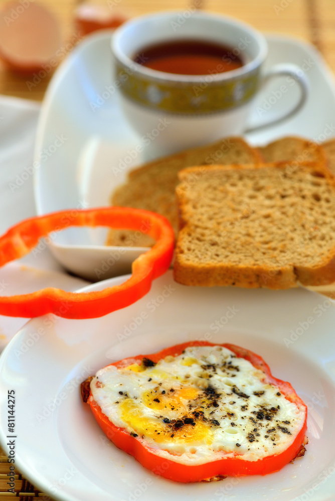 Egg (bullseye) in capsicum with brown bread and tea Egg (bullseye) in capsicum with brown bread and tea