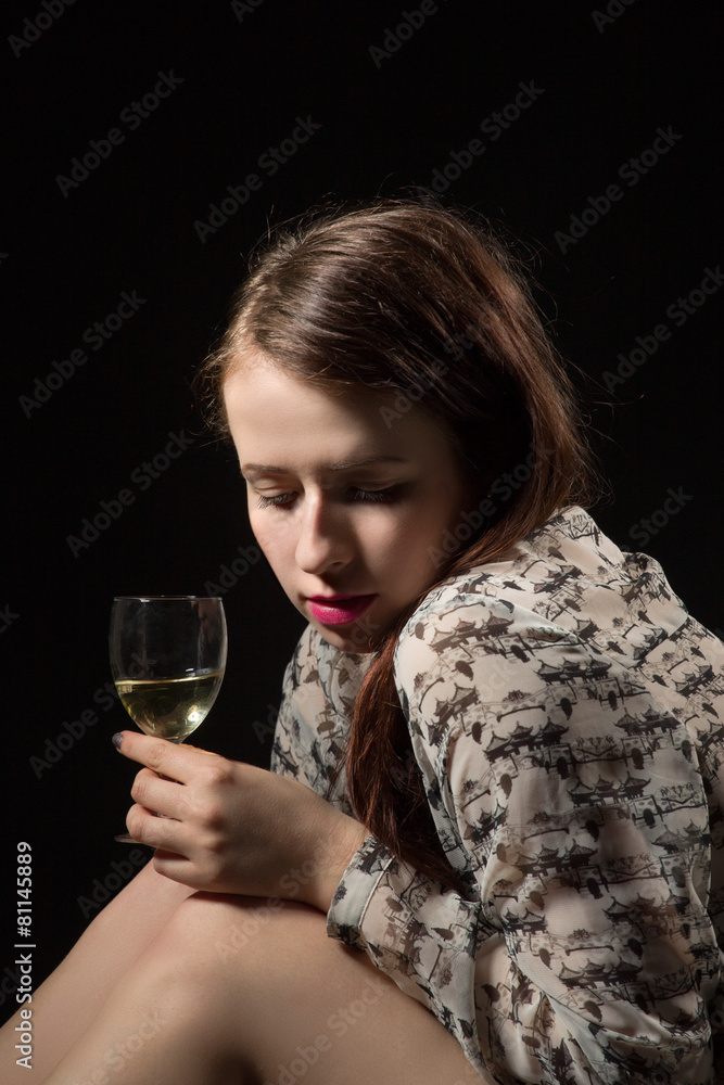 beautiful young brunette woman holding a glass of white wine beautiful young brunette woman holding a glass of white wine