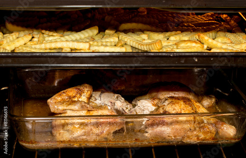 fresh chicken and french fries in oven