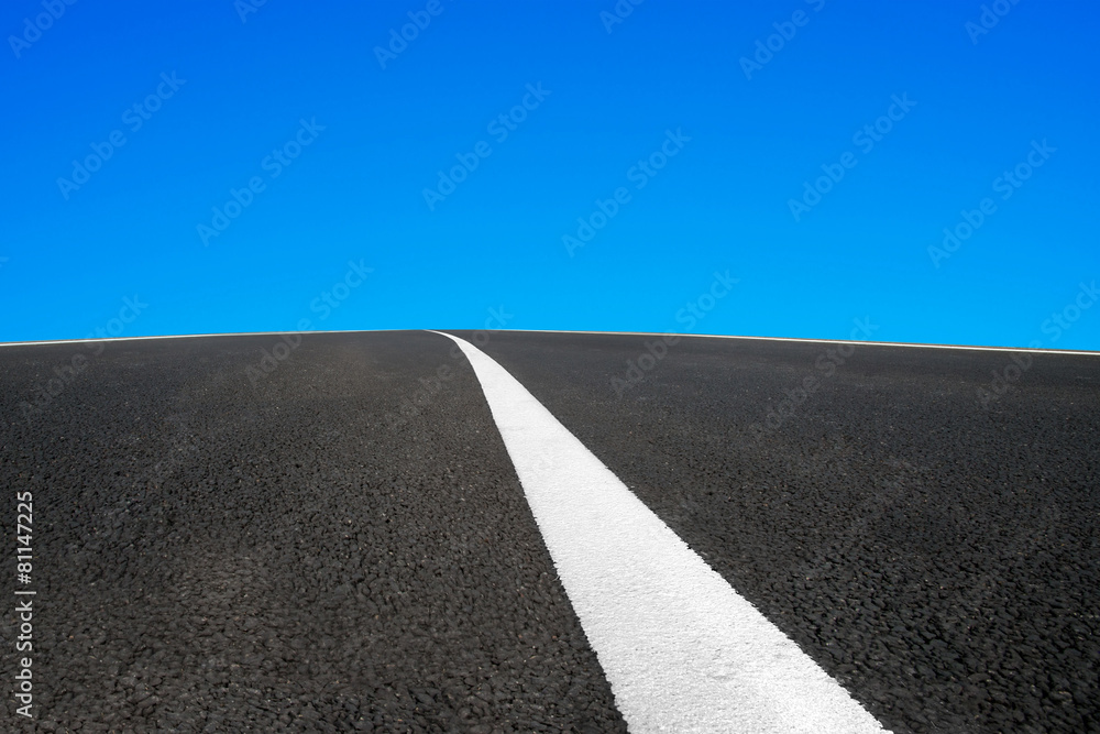 Asphalt road with white line and blue sky