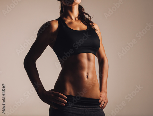 Muscular young woman in sportswear