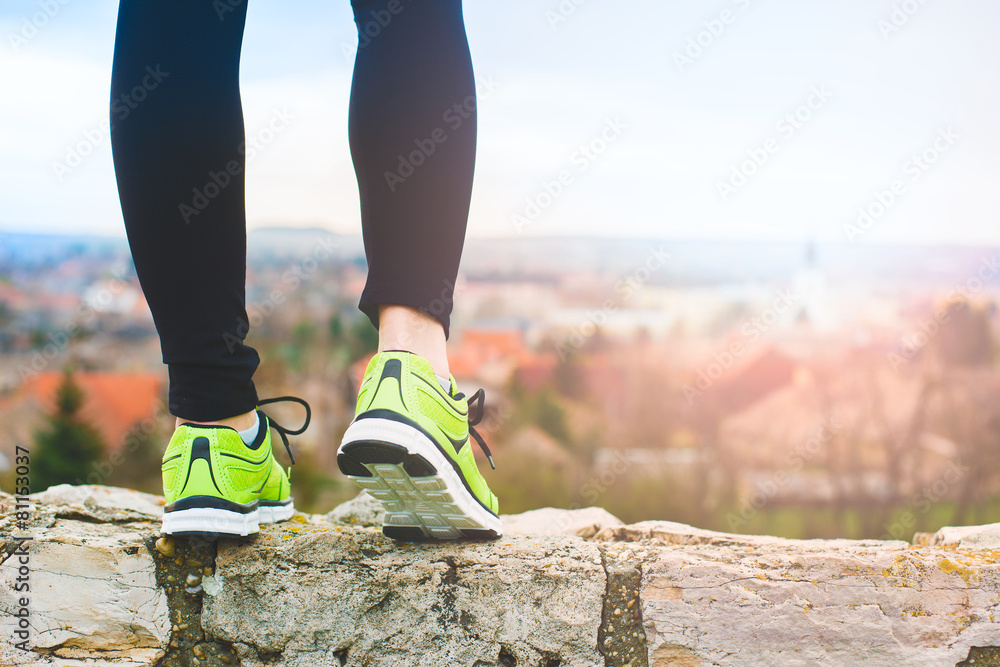 Runner feet running on the top of a hill Runner feet running on the top of a hill