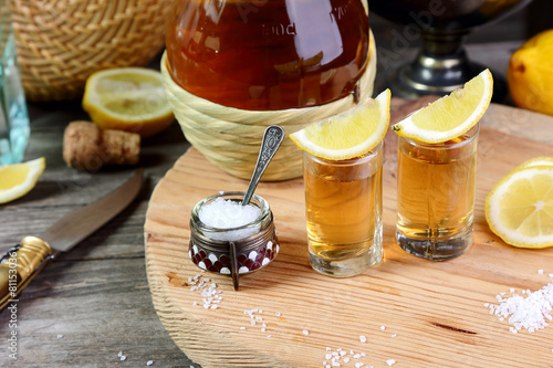 Two glasses of tequila with lemon and salt photo