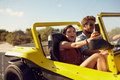 Excited happy couple enjoying on a road trip