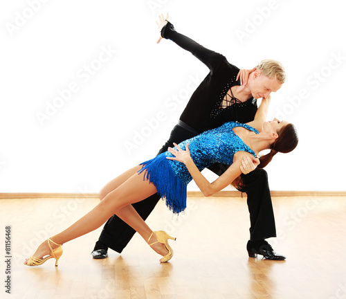 Beautiful couple in active ballroom dance, indoors