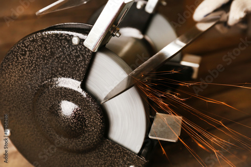 Fotografie Knife sharpener on wooden table, closeup