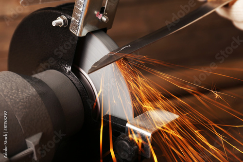Принти на полотні Knife sharpener on wooden table, closeup