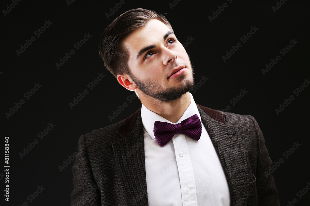 Elegant man in suit on dark background Elegant man in suit on dark background