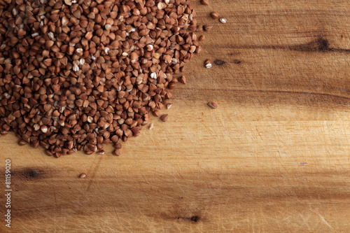 Grains of buckwheat on the kitchen board