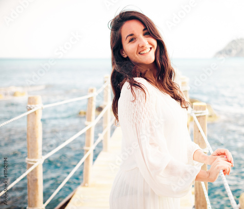 woman on the bridge near sea