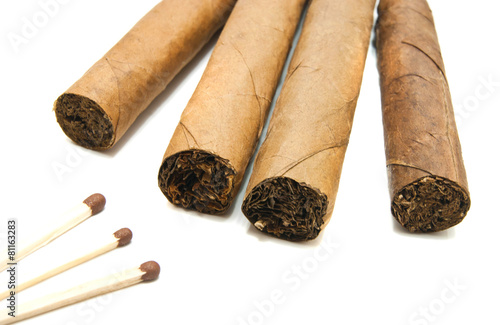 four cigars and matches on white photo