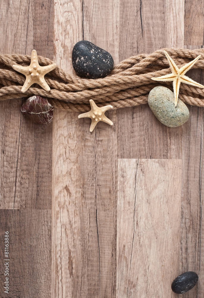 rope, starfish, sea stones on the old wooden background rope, starfish, sea stones on the old wooden background