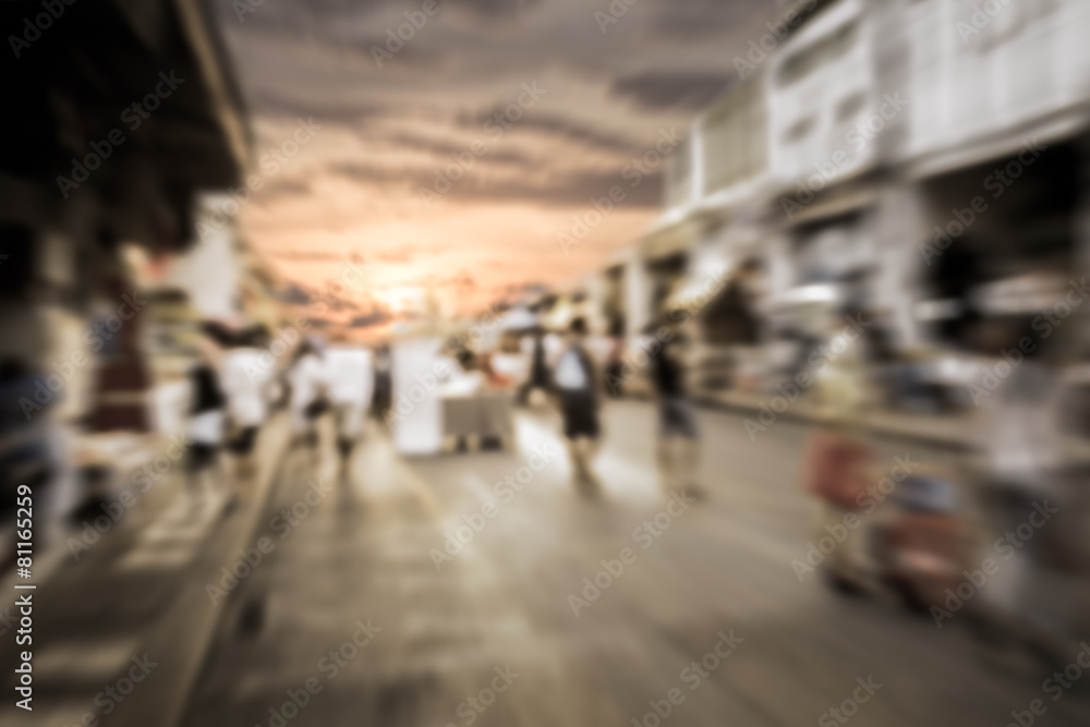 Blurred people walking on the street during sunset Blurred people walking on the street during sunset