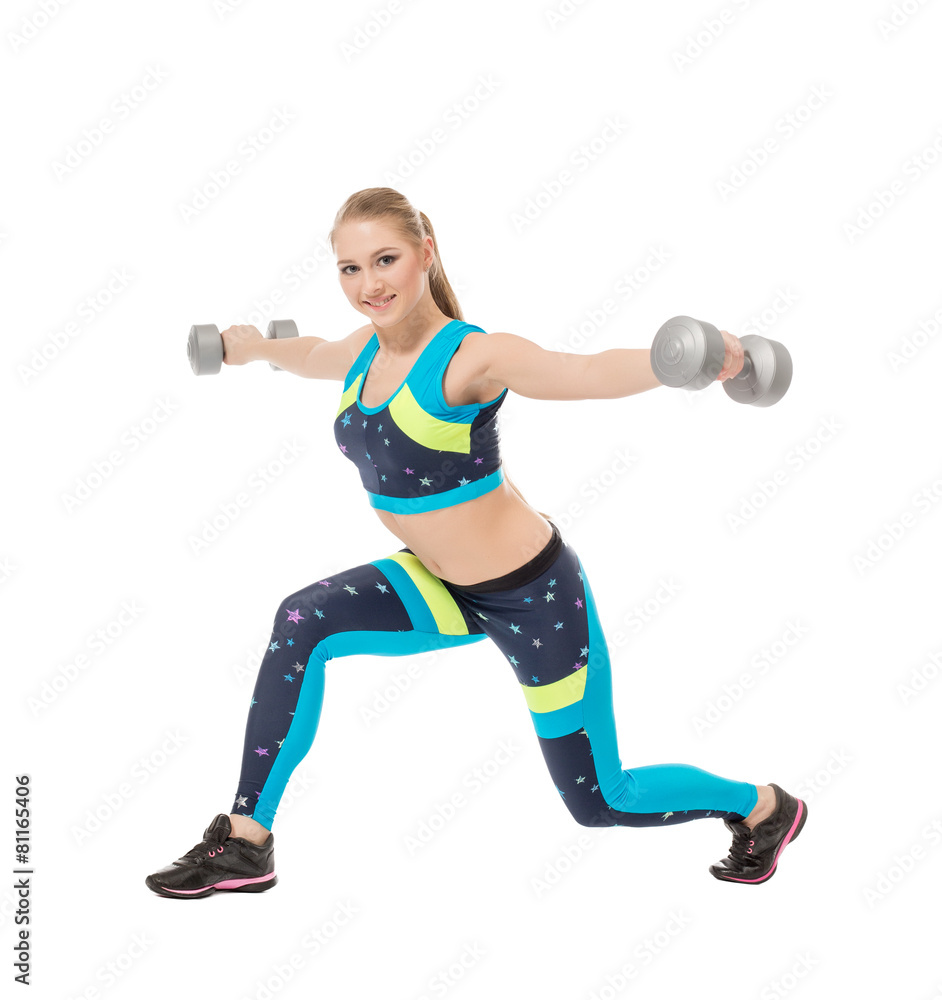 Cute sporty girl posing with dumbbells Cute sporty girl posing with dumbbells