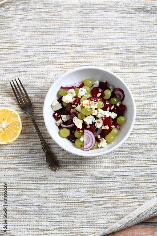Homemade salad with beet, grapes and onions