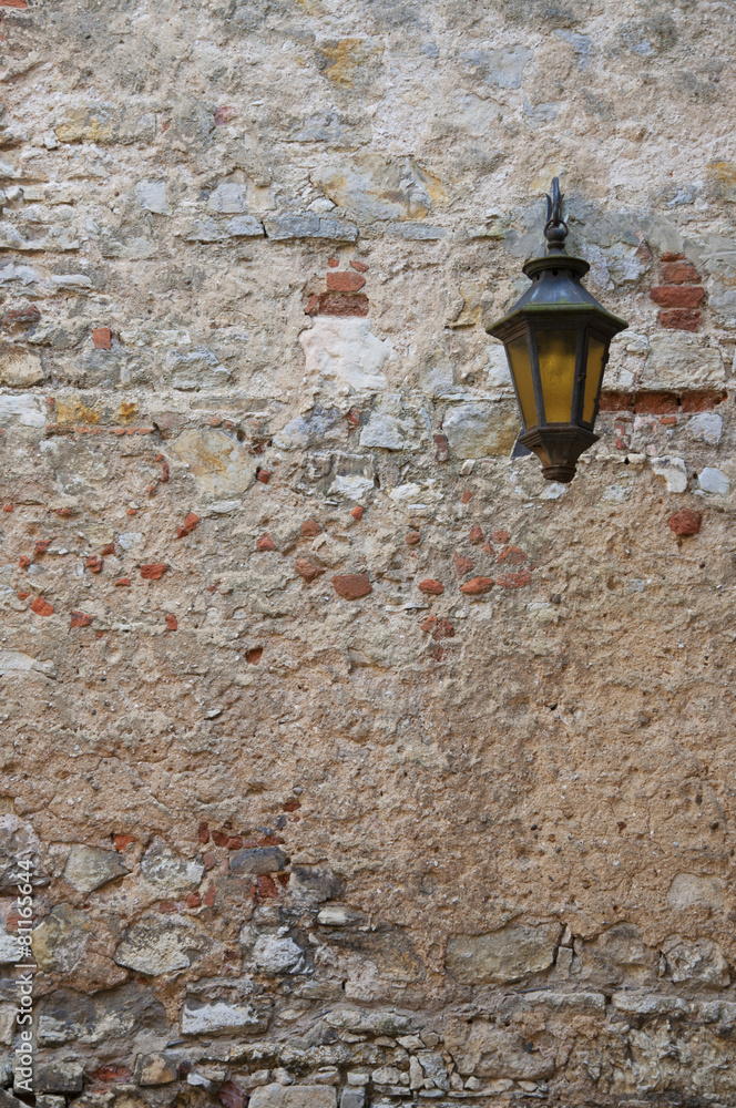 Old street lamp on a wall