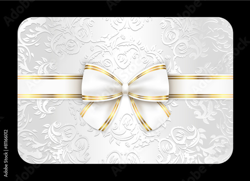 White card with ornament and white ribbon
