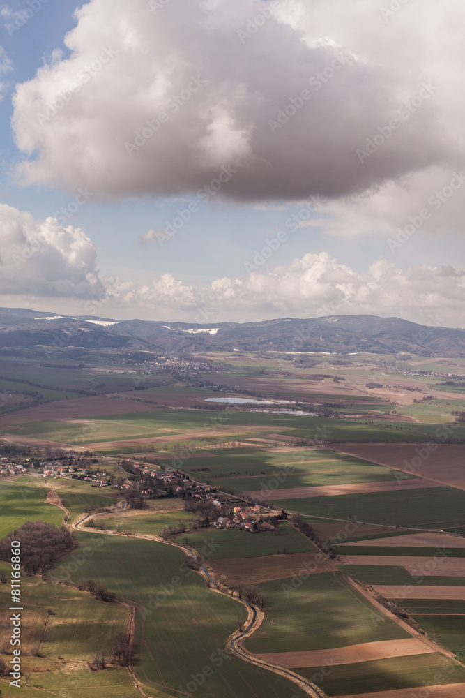 Fototapeta premium aerial view of spring time village harvest fields landscape