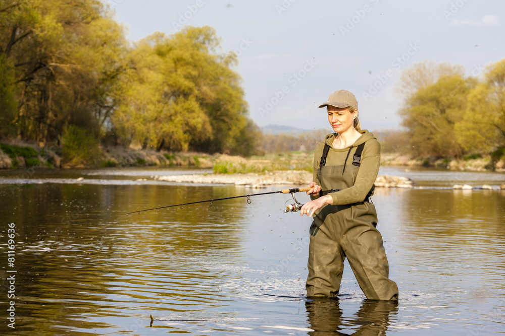 woman fishing in the river in spring woman fishing in the river in spring