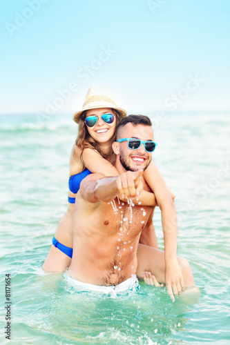 Happy couple having fun at the beach