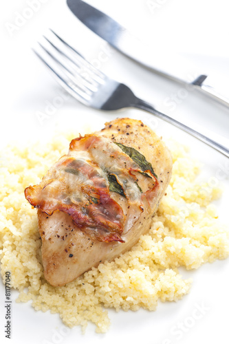 chicken meat on sage baked with bacon and served with couscous