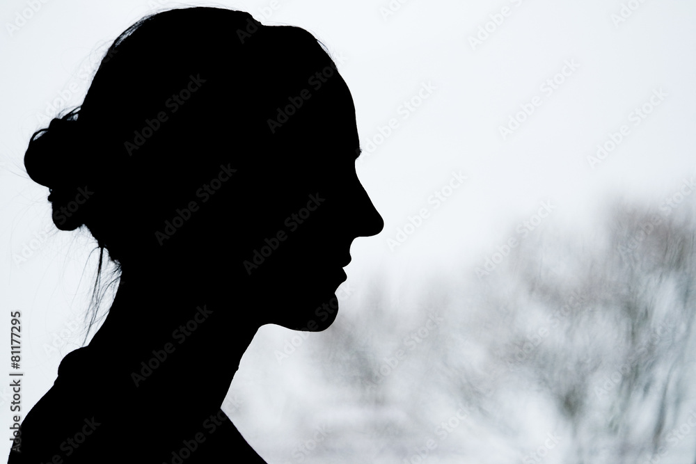 Lady Silhouette with blurry tree background Lady Silhouette with blurry tree background