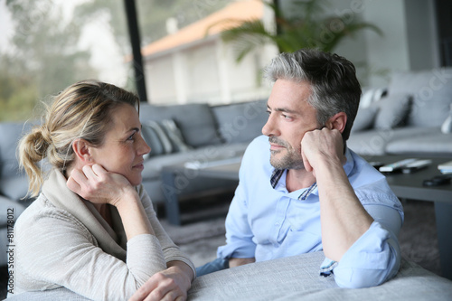 Mature couple talking to each other in sofa