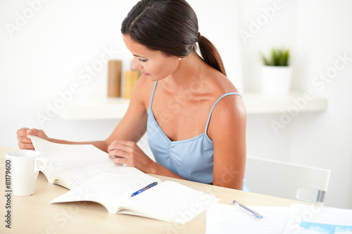 Friendly latin female reading her books