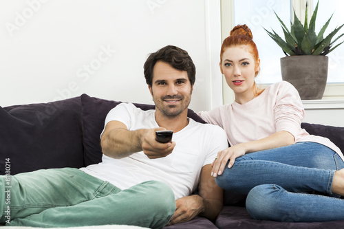 Happy Young Sweet Couple Sitting at the Couch