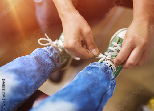 Fotografija Father tying shoe laces of his son traveling in train.